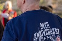A participant of a 9/11 commemoration ceremony listens to Jill Fewell, Daughters of the American Revolution Caroline Scott Harrison Chapter regent, at the Indiana 9/11 Memorial in Indianapolis Sept. 11, 2025. Soldiers and civilians from the U.S. Army Financial Management Command joined the DAR, the Indianapolis Fire Department’s Station 13, police officers from various agencies and members of the public to commemorate the 24th anniversary of the terrorist attacks on Sept. 11, 2001. (U.S. Army photo by Mark R. W. Orders-Woempner)