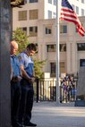 Firefighters from the Indianapolis Fire Department’s Station 13 take part in a moment of silence during a commemoration ceremony at the Indiana 9/11 Memorial in Indianapolis Sept. 11, 2025. Standing between the firefighters and the flag was a beam from one of the towers at the World Trade Center, which was destroyed by the terrorist attacks on Sept. 11, 2001. (U.S. Army photo by Mark R. W. Orders-Woempner)