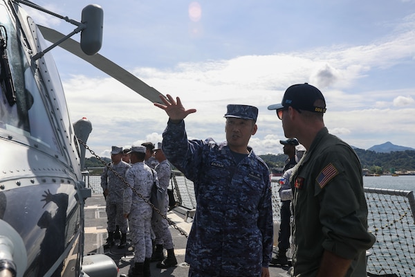 Lt. Sam Melin, from Tacoma, Washington, teaches Cmdr. Noriyuki Kawahata, Assistant Defense Attaché of Japan to the Philippines, about flight operations on the flight deck aboard the Arleigh Burke-class guided-missile destroyer USS John Finn (DDG 113) during a subject matter exchange as part of Resolute Dragon in Subic Bay, Philippines, Sept. 11.