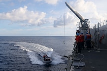 Sailors aboard the Arleigh Burke-class guided-missile destroyer USS John Finn (DDG 113) conduct a small boat operation during Maritime Cooperative Activity with the Osumi-class tank landing ship JS Osumi (LST-4001) and the Jose Rizal-class frigate BRP Jose Rizal (FF-150) in the South China Sea, Sept. 13.