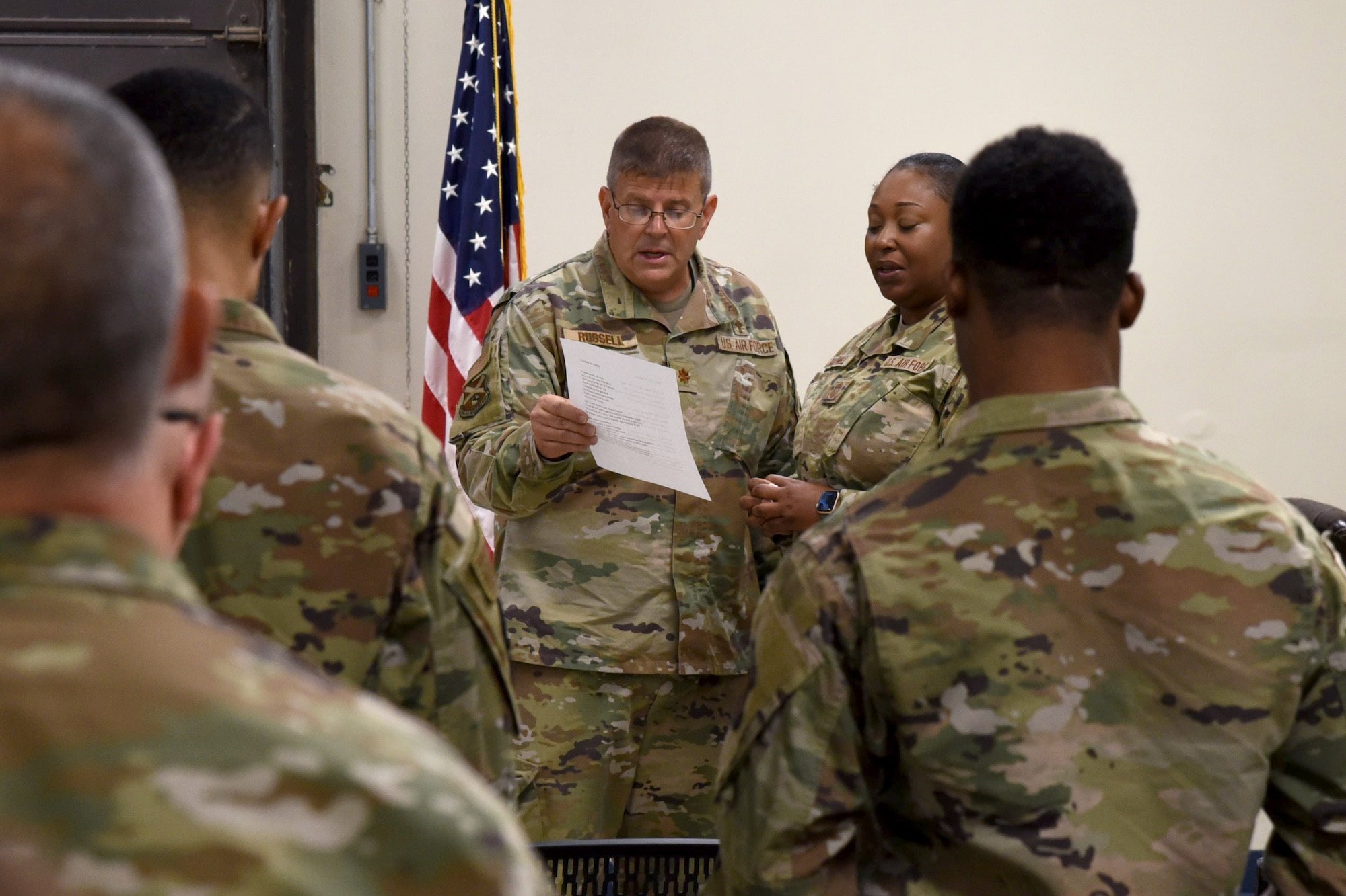 From left, U.S. Air Force Chaplain (Maj.) John Russell, 117th Air Refueling Wing chaplain, and U.S. Air Force Senior Master Sgt. Jackie Barnwell, supervisor for the 117 ARW Finance Office, sing with other Airmen during a worship service on Sept. 14, 2025, at Sumpter Smith Joint National Guard Base, Alabama.