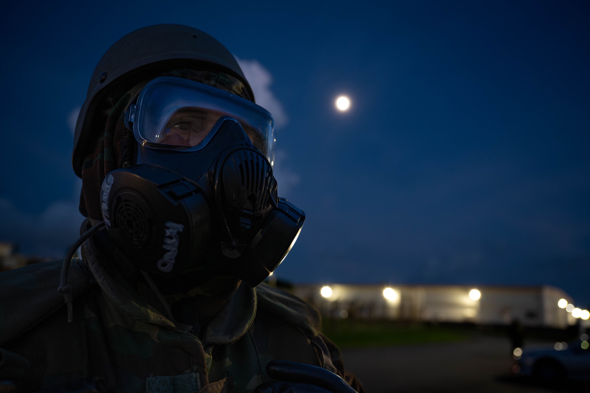 A U.S. Air Force Airman assigned to the 18th Wing, poses in full mission oriented protective posture gear during a chemical, biological, radiological and nuclear defense course at Kadena Air Base, Japan, Sept. 4, 2025. The gas mask filters out harmful particles and vapors, allowing service members to breathe safely in contaminated environments. (U.S. Air Force photo by Airman Nathaniel Jackson)