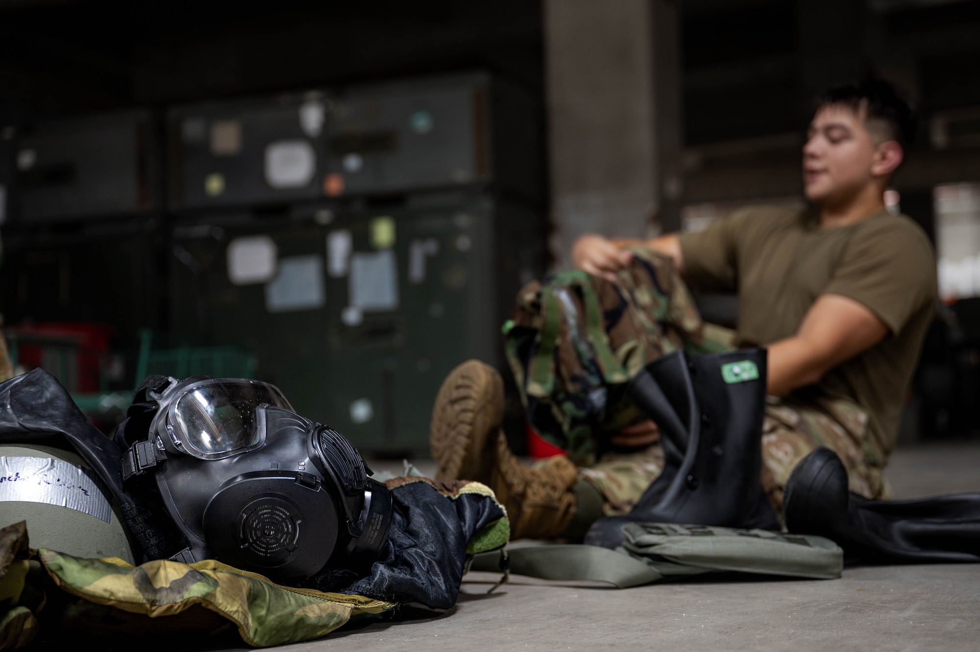 A set of mission oriented protective posture gear lays on the ground after being taken off during a chemical, biological, radiological and nuclear defense course at Kadena Air Base, Japan, Sept. 4, 2025. MOPP gear is layered protective equipment that service members wear to protect their skin and lungs from toxic agents. (U.S. Air Force photo by Airman Nathaniel Jackson)