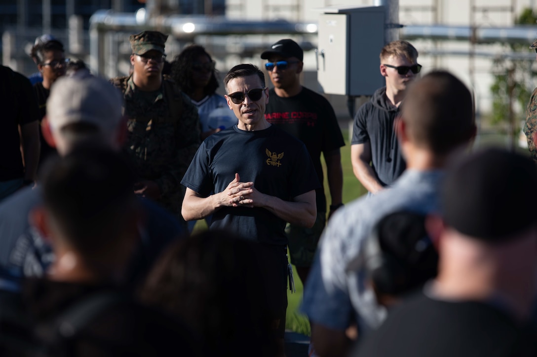 U.S. Navy LCDR Michael Gaona, a family physician with Navy Medical Readiness and Training Command Iwakuni, Marine Corps Air Station Iwakuni talks to community members before the start of a suicide prevention and awareness walk at MCAS Iwakuni, Sept. 05, 2025. The suicide prevention and awareness walk was held to bring the community together and spread awareness about the resources available to those affected by suicide.