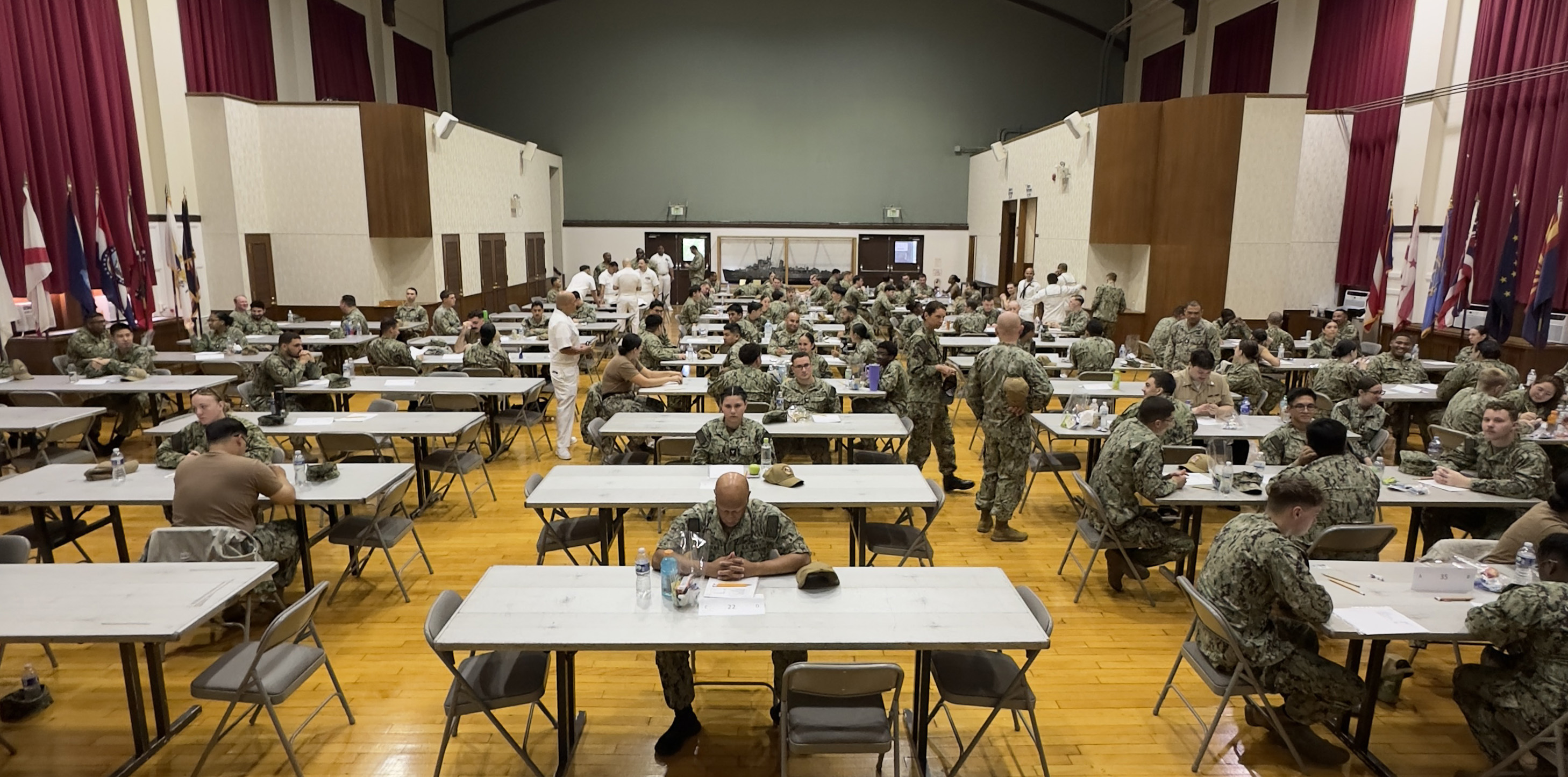 A group of petty officers third class takes the E-5 Navy-Wide Advancement Exam (NWAE) at Commander, Fleet Activities Yokosuka’s C2 Auditorium. The NWAE is a biannual exam that tests Sailors’ rating-specific knowledge for advancement to the next paygrade.