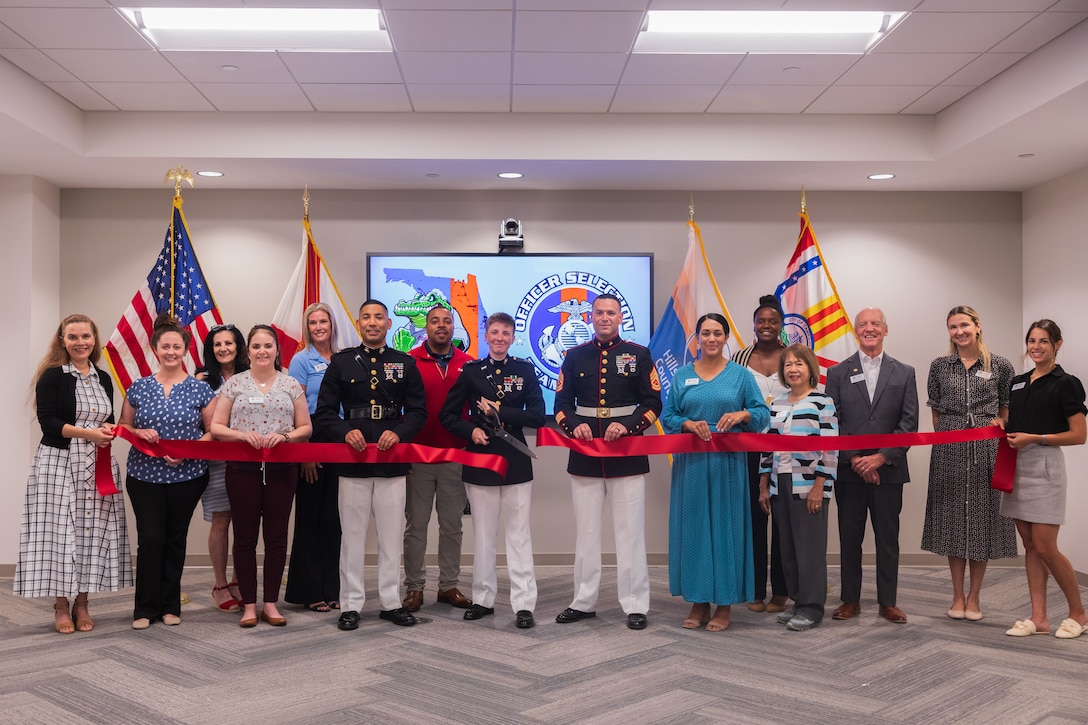 U.S. Marines with Officer Selection Team (OST) Tampa of Recruiting Station Tampa, alongside members of the Tampa Bay Chamber of Commerce, conduct a ribbon-cutting ceremony to showcase the activation of OST Tampa on Sep. 4, 2025, at the Tampa Bay Chamber of Commerce. The new team was created as part of a larger plan to improve how the Marine Corps finds and recruits future officers. This plan is based on updated population data, which helps the Marine Corps focus on areas with more eligible young people. (U.S. Marine Corps photo by Cpl. Jaylen Davis)