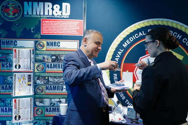 BETHESDA, Md. (Sept. 11, 2025) Farrukh Rizvi, a program manager with Naval Medical Research Command’s (NMRC) Naval Advanced Medical Development department demonstrates a wound care treatment during a Health Services Operational Advisory Group (HSOAG) meeting. Marine Corps Health Services, led by Rear Adm. Guido Valdes, The Medical Officer (TMO) of the Marine Corps, advises the Commandant and Marines Headquarters staff on all healthcare matters. TMO serves as the functional expert in working with the appropriate Headquarters agencies for determining medical requirements and makes recommendations on all medical matters relevant to supporting the Marine Corps. NMRC, headquarters of Navy Medicine Research & Development, is engaged in a broad spectrum of activity from basic science in the laboratory to field studies in austere and remote areas of the world to investigations in operational environments. In support of Navy, Marine Corps and joint U.S. warfighter health, readiness and lethality, researchers study infectious diseases, biological warfare detection and defense, combat casualty care, environmental health concerns, aerospace and undersea medicine, operational mission support and epidemiology. (U.S. Navy photo by Aleece Williams/Released)