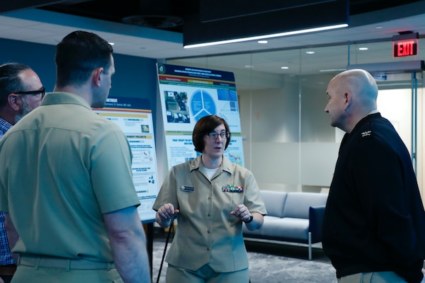 BETHESDA, Md. (Sept. 11, 2025) Lt. Cmdr. Danett Bishop with Naval Medical Research Command (NMRC), engages with Capt. Eric Welsh, commander, NMRC, and Master Chief Hospital Corpsman Christopher Cariss, NMRC command master chief, during a Health Services Operational Advisory Group (HSOAG) meeting. Marine Corps Health Services, led by Rear Adm. Guido Valdes, The Medical Officer (TMO) of the Marine Corps, advises the Commandant and Marines Headquarters staff on all healthcare matters. TMO serves as the functional expert in working with the appropriate Headquarters agencies for determining medical requirements and makes recommendations on all medical matters relevant to supporting the Marine Corps. NMRC, headquarters of Navy Medicine Research & Development, is engaged in a broad spectrum of activity from basic science in the laboratory to field studies in austere and remote areas of the world to investigations in operational environments. In support of Navy, Marine Corps and joint U.S. warfighter health, readiness and lethality, researchers study infectious diseases, biological warfare detection and defense, combat casualty care, environmental health concerns, aerospace and undersea medicine, operational mission support and epidemiology. (U.S. Navy photo by Aleece Williams/Released)