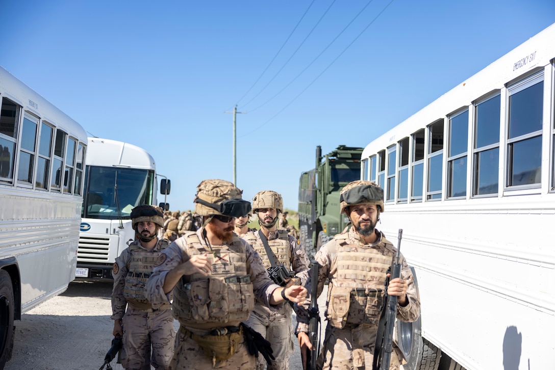 Marines with Infantería de Marina (Spanish marine corps), load into buses during exercise UNITAS 2025 at Onslow Beach, Marine Corps Base Camp Lejeune, North Carolina, Sep. 12, 2025. UNITAS, which is Latin for “unity,” was conceived in 1959 and has taken place annually since first conducted in 1960. This year marks the 66th iteration of the world’s longest running annual multinational maritime exercise. (U.S. Marine Corps photo by Lance Cpl. Payton Goodrich)