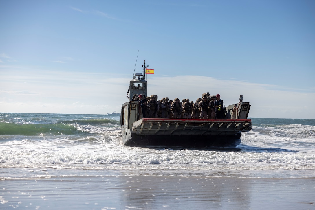 Marines with Infantería de Marina, (Spanish marine corps), disembark from a landing craft mechanized at Onslow Beach in preparation to execute exercise UNITAS 2025, Marine Corps Base Camp Lejeune, North Carolina, Sep. 12, 2025. UNITAS, which is Latin for “unity,” was conceived in 1959 and has taken place annually since first conducted in 1960. This year marks the 66th iteration of the world’s longest running annual multinational maritime exercise. (U.S. Marine Corps photo by Lance Cpl. Payton Goodrich)