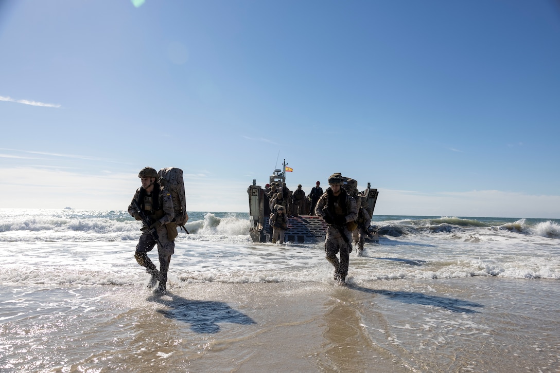 Marines with Infantería de Marina, (Spanish marine corps), disembark from a landing craft mechanized at Onslow Beach in preparation to execute exercise UNITAS 2025, Marine Corps Base Camp Lejeune, North Carolina, Sep. 12, 2025. UNITAS, which is Latin for “unity,” was conceived in 1959 and has taken place annually since first conducted in 1960. This year marks the 66th iteration of the world’s longest running annual multinational maritime exercise. (U.S. Marine Corps photo by Lance Cpl. Payton Goodrich)