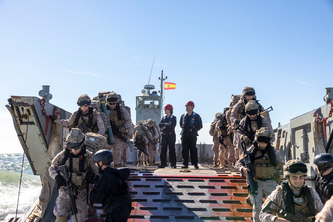 Marines with Infantería de Marina, (Spanish marine corps), disembark from a landing craft mechanized at Onslow Beach in preparation to execute exercise UNITAS 2025, Marine Corps Base Camp Lejeune, North Carolina, Sep. 12, 2025. UNITAS, which is Latin for “unity,” was conceived in 1959 and has taken place annually since first conducted in 1960. This year marks the 66th iteration of the world’s longest running annual multinational maritime exercise. (U.S. Marine Corps photo by Lance Cpl. Payton Goodrich)