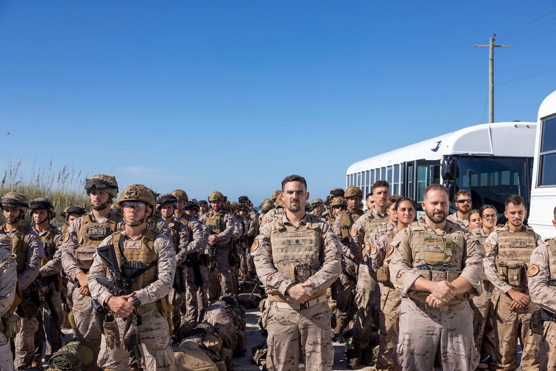 Marines with Infantería de Marina (Spanish marine corps), stand in formation for before boarding buses during exercise UNITAS 2025 at Onslow Beach, Marine Corps Base Camp Lejeune, North Carolina, Sep. 12, 2025. UNITAS, which is Latin for “unity,” was conceived in 1959 and has taken place annually since first conducted in 1960. This year marks the 66th iteration of the world’s longest running annual multinational maritime exercise. (U.S. Marine Corps photo by Lance Cpl. Payton Goodrich)