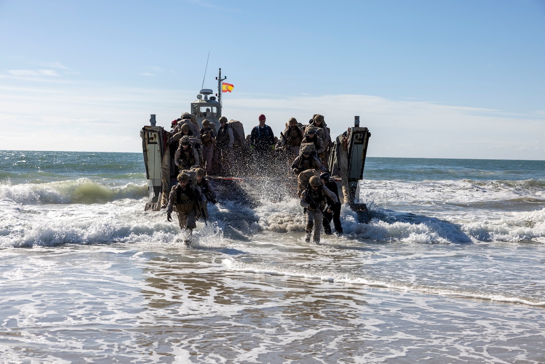 Marines with Infantería de Marina, (Spanish marine corps), disembark from a landing craft mechanized at Onslow Beach in preparation to execute exercise UNITAS 2025, Marine Corps Base Camp Lejeune, North Carolina, Sep. 12, 2025. UNITAS, which is Latin for “unity,” was conceived in 1959 and has taken place annually since first conducted in 1960. This year marks the 66th iteration of the world’s longest running annual multinational maritime exercise. (U.S. Marine Corps photo by Lance Cpl. Payton Goodrich)