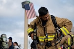 Alec Cano, 902d Civil Engineer Squadron firefighter, prepares for the San Antonio 110 9/11 Memorial Climb at the Alamodome, San Antonio, Texas, Sept. 11, 2025. The Joint Base San Antonio firefighters donned approximately 80 pounds of gear while climbing the equivalent of 110 stories, demonstrating their physical readiness and dedication to the task at hand while honoring the more than 340 firefighters who died following the 9/11 attacks. (U.S. Air Force photo by Kathryn R.C. Reaves)