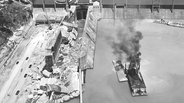This is an aerial view of Wheeler Lock in June of 1961 shortly after the needle dam had been placed in the upstream lock gate opening. Much of the wall nearest shore slid about 30 feet, and parts of it collapsed into the lock. The photo was included in a TVA report titled “Wheeler Lock Failure” written in November 1961. For the purposes of loading this photo online, the date of June 23, 1961, was chosen, but the exact date could not be determined. The photo shows a coffer dam inside the lock downstream approach, which would have taken some time to construct to begin repairs. (TVA photo by Orvel Dean)