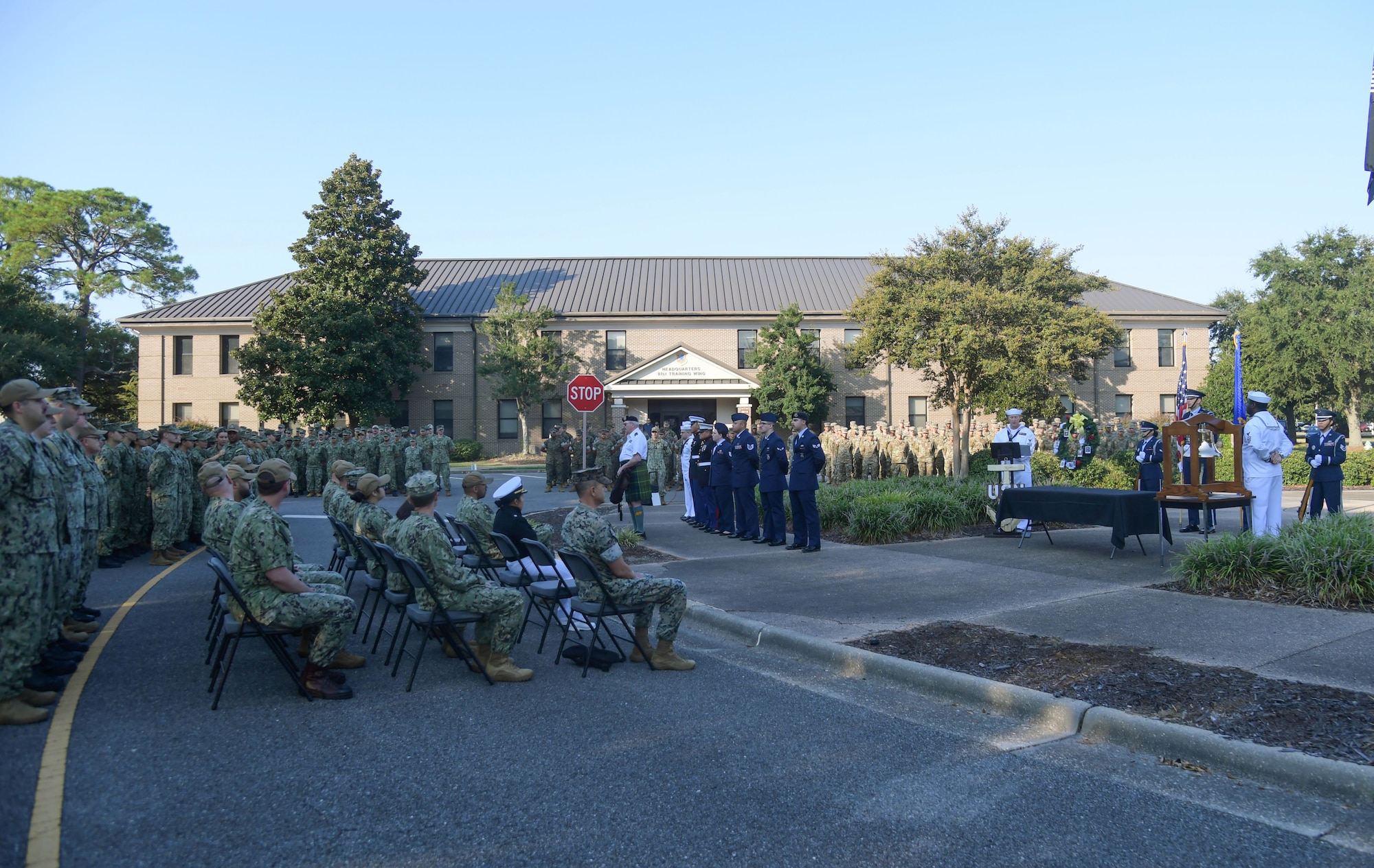A group of people in military uniform gather for a ceremony
