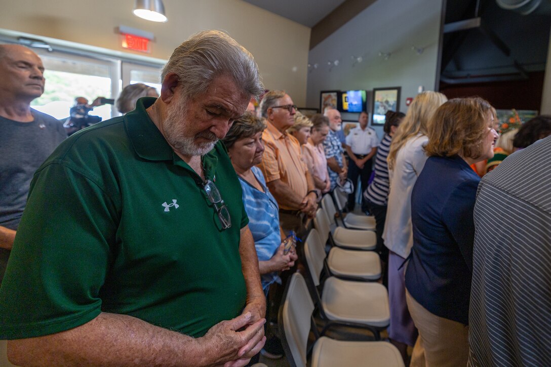 Members of the Plaquemines Parish community bow their heads during the 20th anniversary of the Annual Hurricane Katrina Remembrance benediction at the Fort Jackson Museum Welcome Center, Buras, Louisiana, Aug. 29, 2025. The 20th anniversary honored the resilience of those who continue to thrive 20 years later. (U.S. Marine Corps photo by Sgt. Aaron TorresLemus)