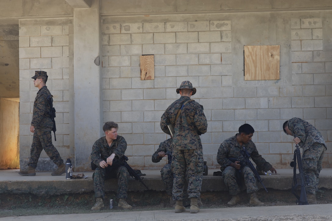 U.S. Marines with the III Marine Expeditionary Force clean their weapons outside the combat operations center in Combat Town, Camp Hansen, Okinawa Japan, Sept. 13, 2025, during the Command Post Exercise portion of Resolute Dragon 25. Resolute Dragon 25 is an annual bilateral exercise across Japan, including the southwest islands, that strengthens the command, control and multidomain maneuver capabilities of III MEF and the Japan Ground Self-Defense Force’s Western Army personnel, alongside representatives across the U.S. and Japanese Joint Force, with a focus on controlling and defending key maritime terrain. (U.S. Marine Corps photo by Gunnery Sgt. Daniel Wetzel)