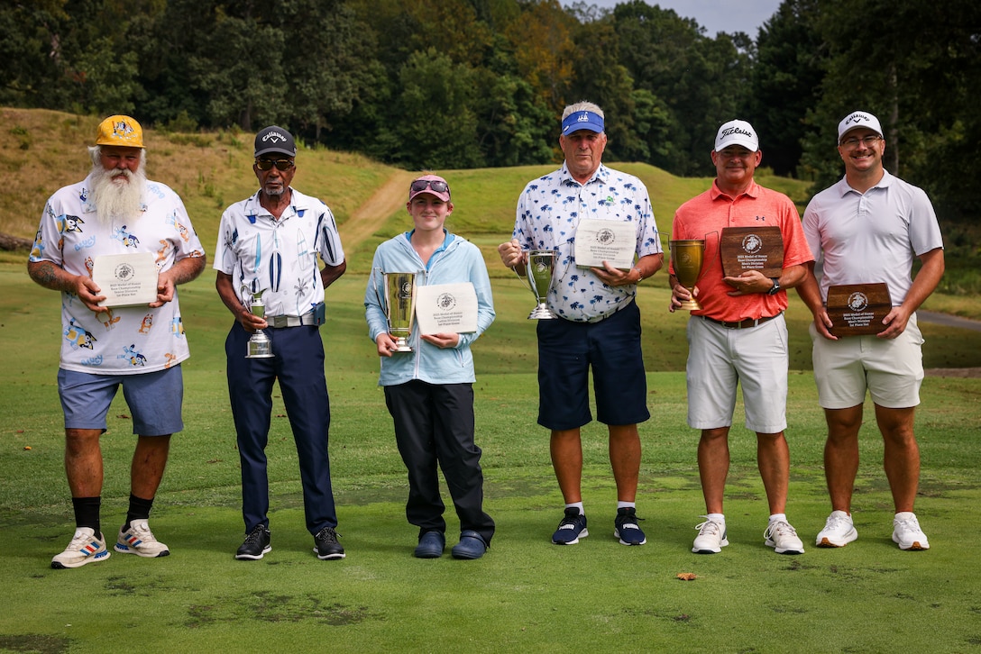 The winners of each division of the 2025 Medal of Honor Golf Course Championship pose together for a group photo at MOHGC on Marine Corps Base Quantico, Virginia, Sept. 8, 2025. The championship highlighted both the high level of competition and the strong partnership between the community and service members. (U.S. Marine Corps photo by Lance Cpl. Jeffery Stevens)