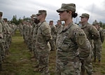Spc. Brianna Coombs, 237th Military Police Company, New Hampshire Army National Guard, stands in formation during a departure ceremony held Oct. 3, 2022, at the Edward Cross Training Complex in Pembroke, New Hampshire. About 170 Soldiers are mobilizing for a year to the U.S.-Mexico border to assist Customs and Border Protection in surveilling and detecting illegal immigrant crossings.