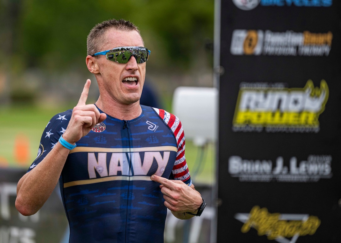 Navy Cmdr. Kyle Hooker crosses the finish line to win his eighth Armed Forces Triathlon championship in San Diego on Sept. 13, 2025. (U.S. Armed Forces Sports phot by Mass Communications Specialist First Class Colby Mothershead - released)
