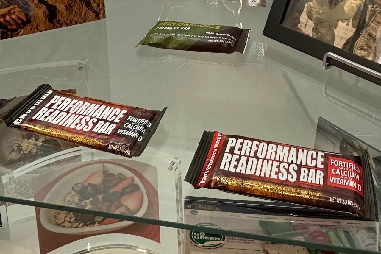 Two packaged bars sit on a glass shelf.