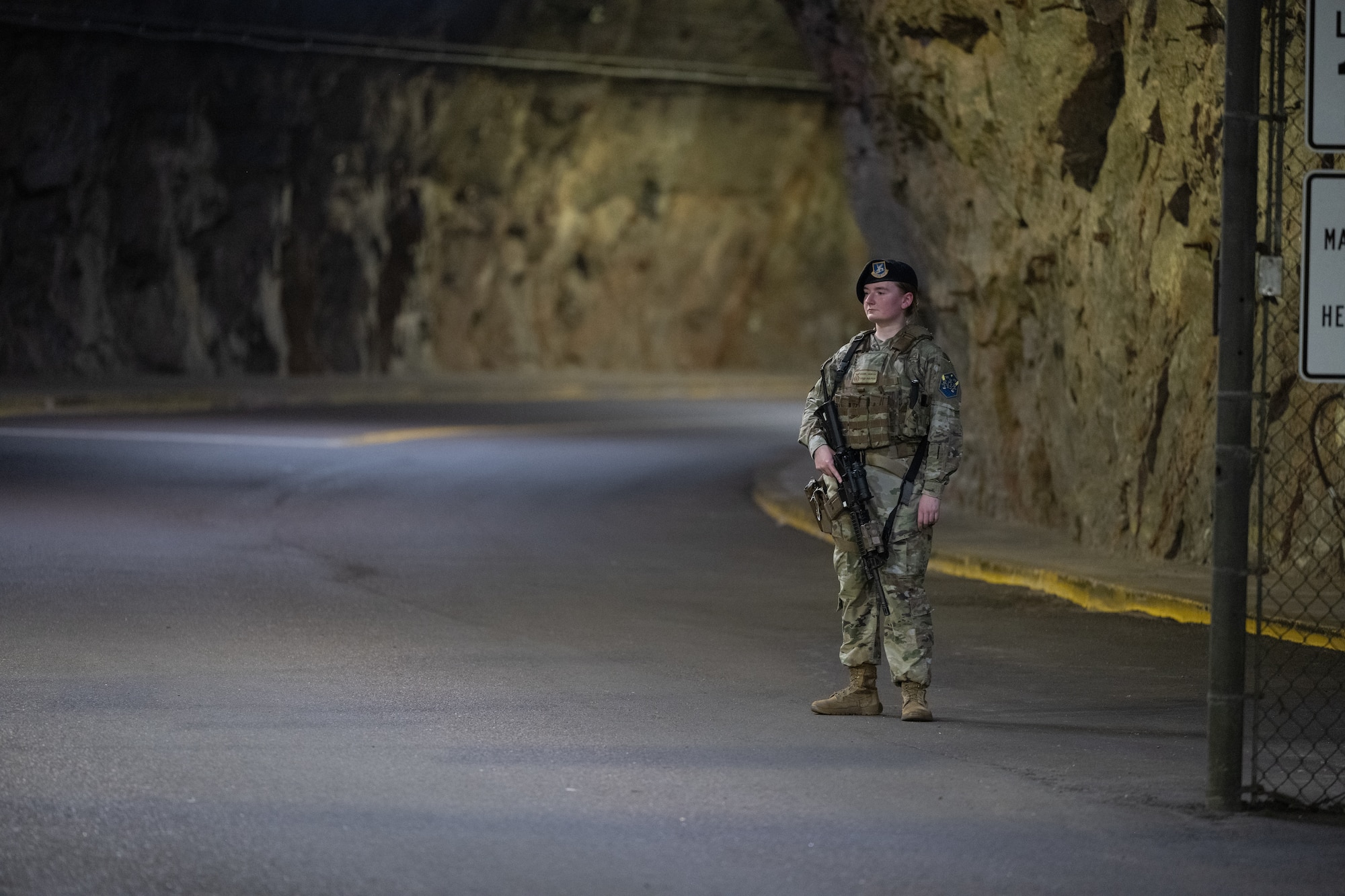 Staff Sgt. Rachel Hunter stands by a gate clearing it to open and close.