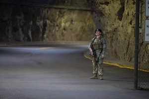 Staff Sgt. Rachel Hunter stands by a gate clearing it to open and close.
