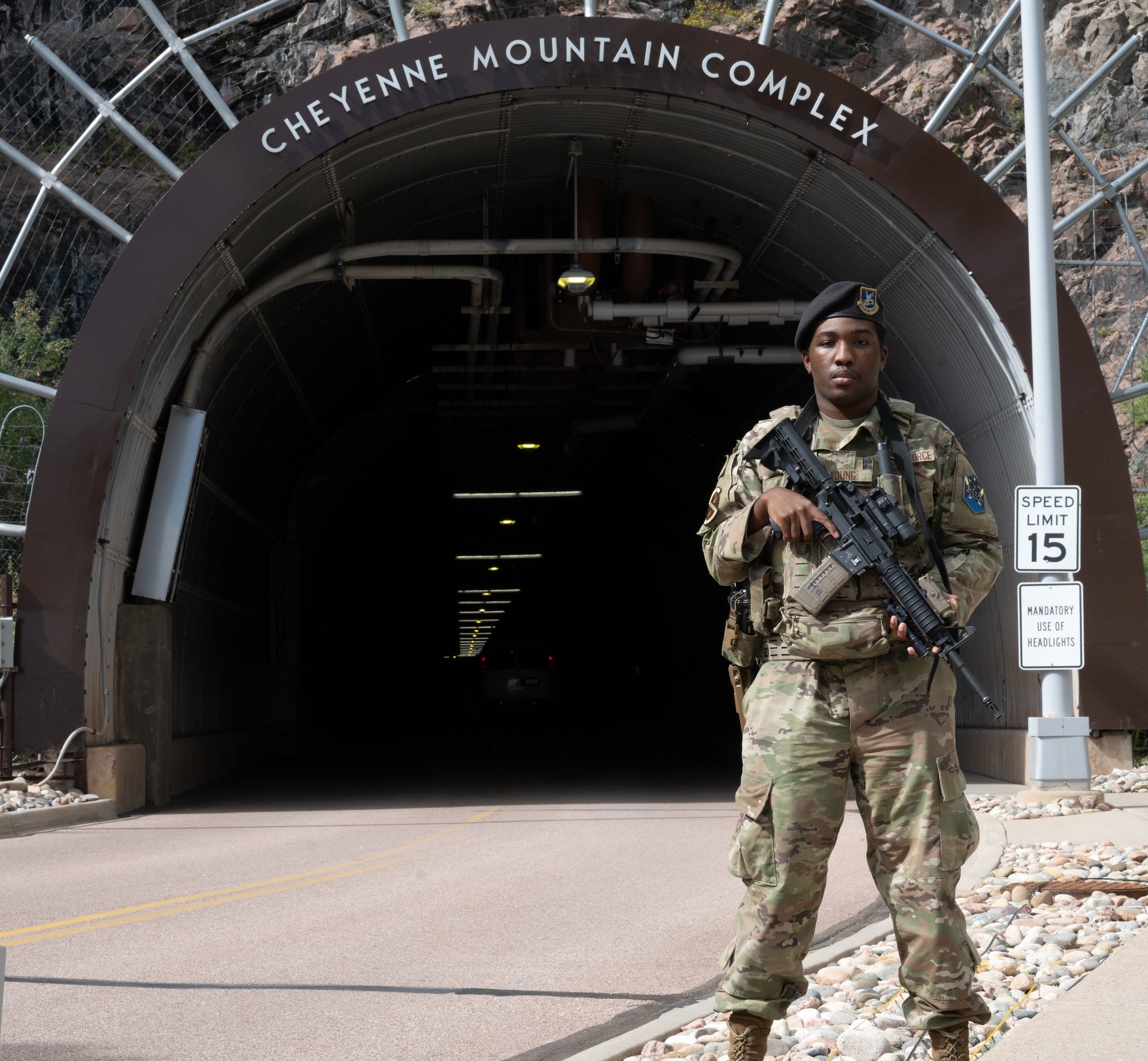 Airman 1st Class Darius Young, stands in front of the tunnel entrance to the Cheyenne Mountain Complex.