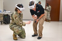 Col. Tracy Bozung, 59th Medical Wing deputy commander works with Retired Col. Cheryl Lockhart, senior military advisor for SimX, during a demonstration of SimX’s Virtual Reality Operational Medical Training at Wilford Hall Ambulatory Surgical Center, Joint Base San Antonio-Lackland, Texas, Sept. 5, 2025.