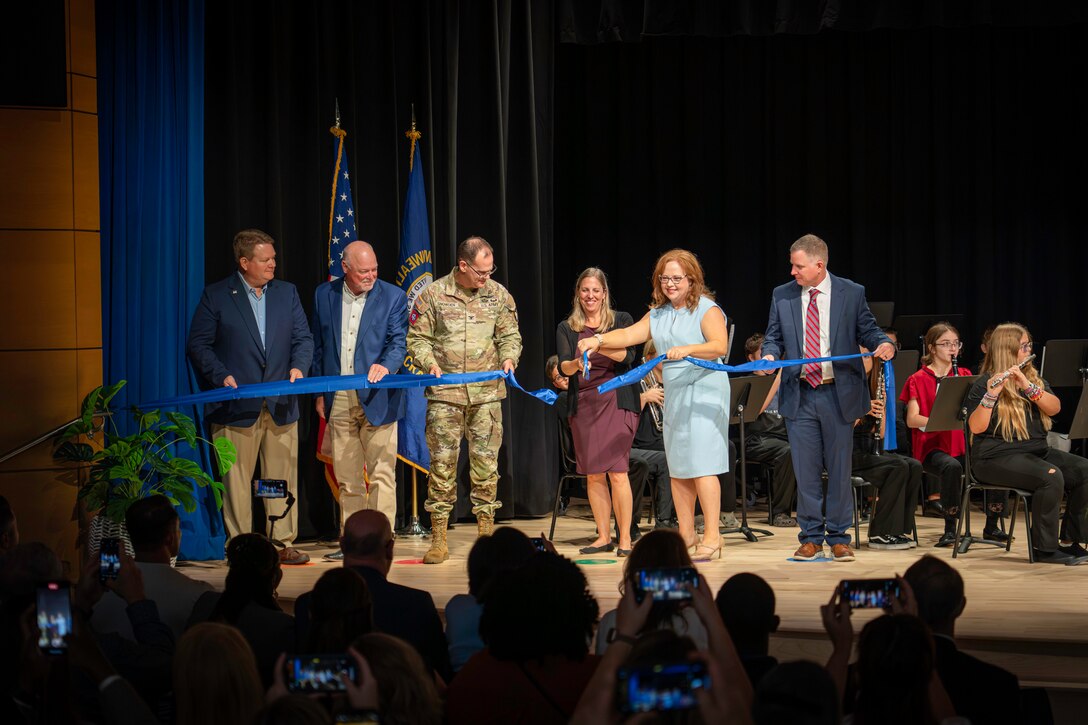 U.S. Army Corps of Engineers Louisville District, Fort Campbell Middle School staff, Fort Campbell leaders, Department of Defense Education Activity members, contractors, and community members cut a ceremonial ribbon to officially dedicate the brand-new Fort Campbell Middle School, Sep. 12, 2025 in Fort Campbell, Kentucky.