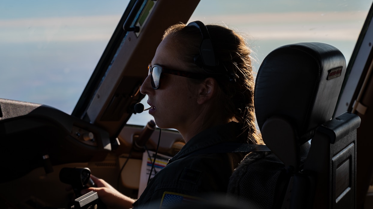 A pilot performs checks in the flight deck