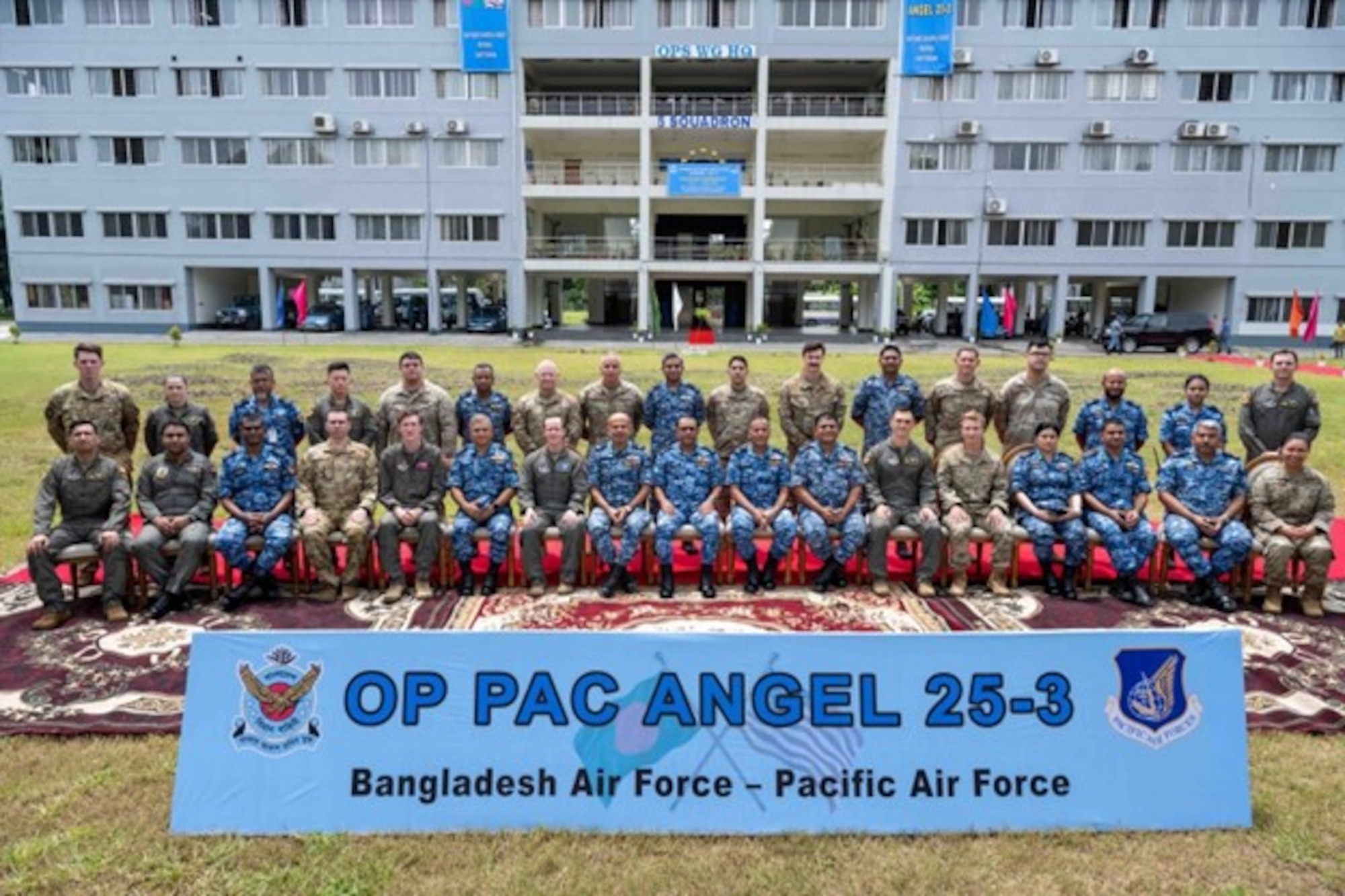U.S. Air Force and Bangladesh Air Force participating in exercise Pacific Angel 25-3 sit and stand for a group photo at BAF Zahurul Haque, Chittagong, Bangladesh, Sept. 13, 2025.