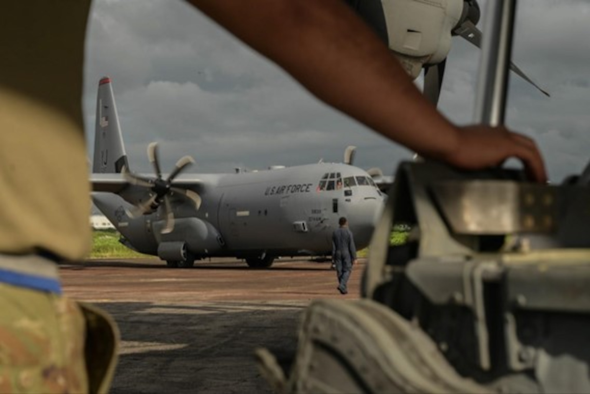 A United States Air Force crew chief watches a C-130J Hercules park during Pacific Angel 25-3 at BAF Base Zahrul Haque in Chittagong, Bangladesh, Sept 12, 2025.