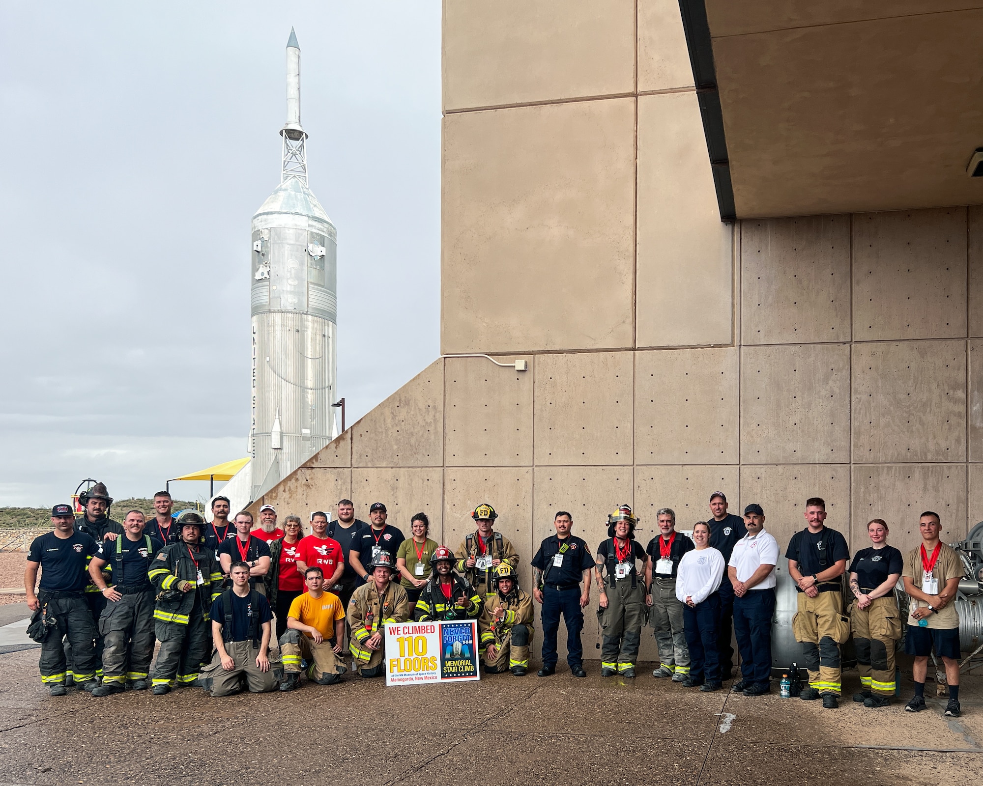 Firefighters representing Holloman Air Force Base, center, and regional fire departments pose for a photo after completing the Climb the Cube 9/11 memorial event at the New Mexico Museum of Space History in Alamogordo, New Mexico, Sept. 13, 2025.