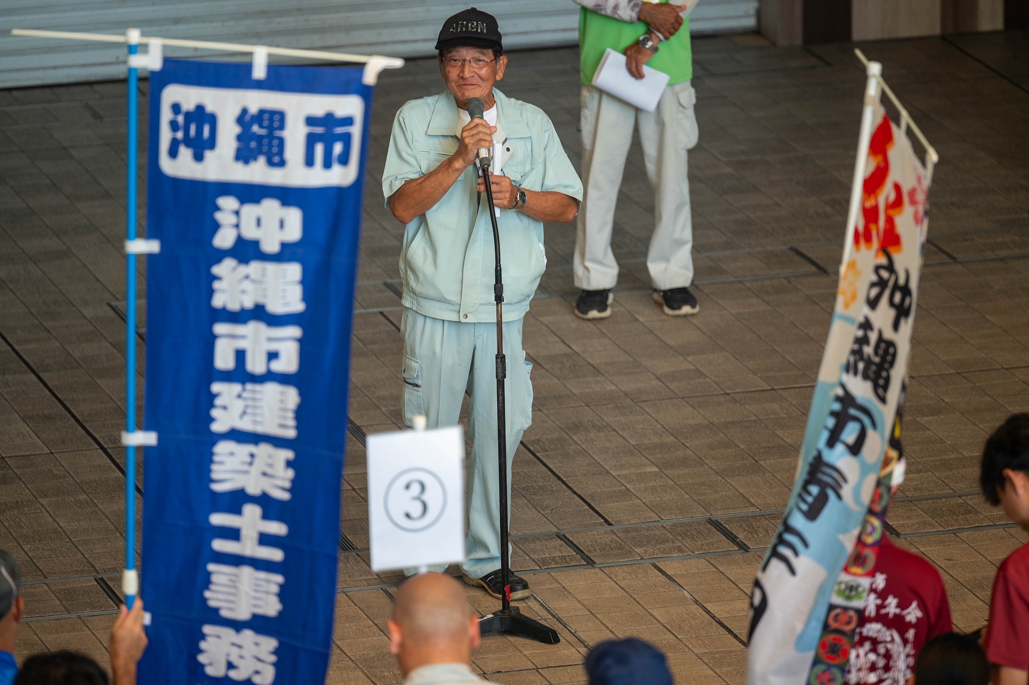 An Okinawa Citizen’s Center representative gives a speech during a bilateral community cleanup event at Kadena Air Base, Japan, Aug. 17 and 31, 2025.