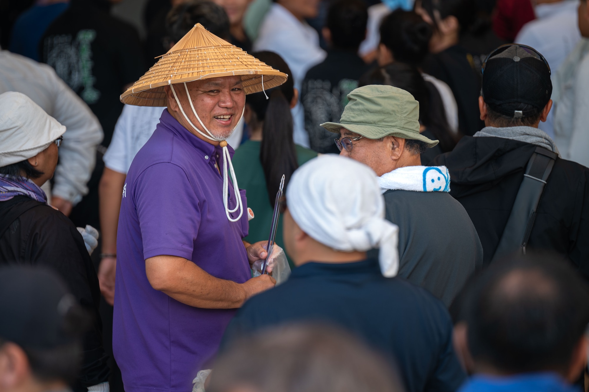 Volunteers converse before the opening ceremony of a bilateral community cleanup event at Kadena Air Base, Japan, Aug. 17 and 31, 2025.