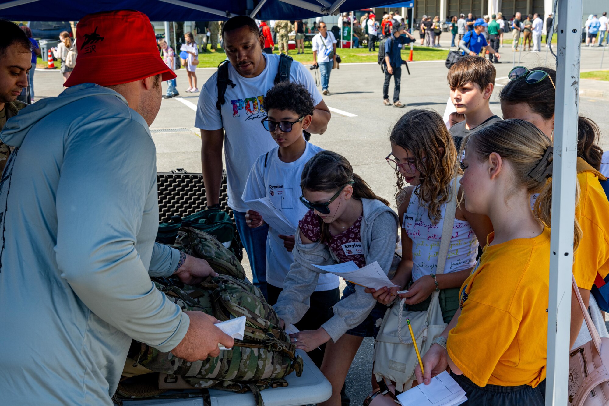 Students from Sollars Elementary School view tactical gear utilized by the 35th Fighter Wing (FW) during Range Day 2025 at Draughon Range.