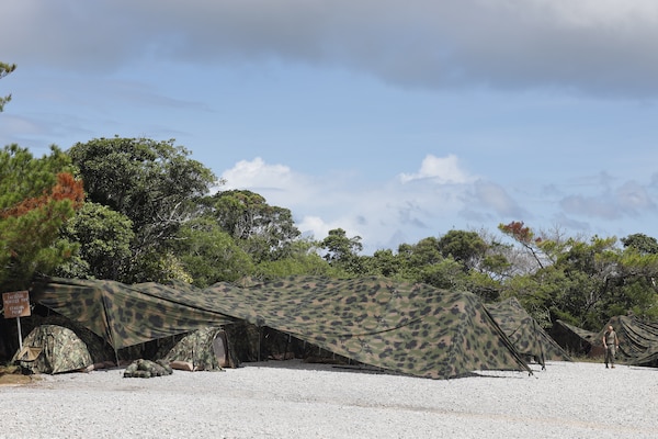 U.S. Marines and Sailors with III Marine Expeditionary Force walk through the tents at the Logistical Support Area outside the combat operations center in Combat Town, Camp Hansen, Okinawa Japan, Sept. 13, 2025, during the Command Post Exercise portion of Resolute Dragon 25. Resolute Dragon 25 is an annual bilateral exercise across Japan, including the southwest islands, that strengthens the command, control and multidomain maneuver capabilities of III MEF and the Japan Ground Self-Defense Force’s Western Army personnel, alongside representatives across the U.S. and Japanese Joint Force, with a focus on controlling and defending key maritime terrain. (U.S. Marine Corps photo by Gunnery Sgt. Daniel Wetzel)