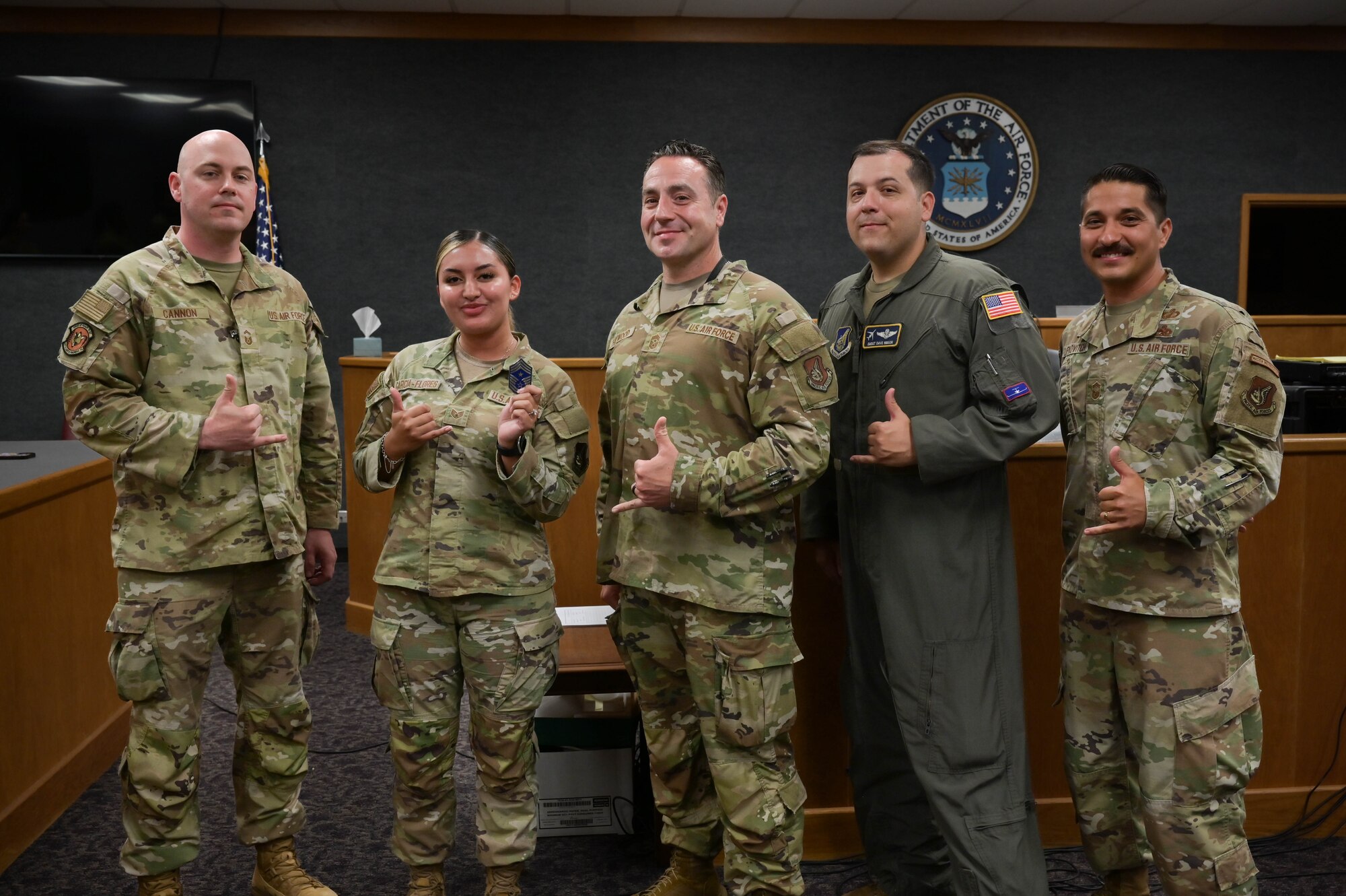 Five Airmen posing for a group photo.