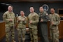 Five Airmen posing for a group photo.