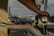 A United States Air Force crew chief watches a C-130J Hercules park during Pacific Angel 25-3 at BAF Base Zahrul Haque in Chittagong, Bangladesh, Sept 12, 2025.