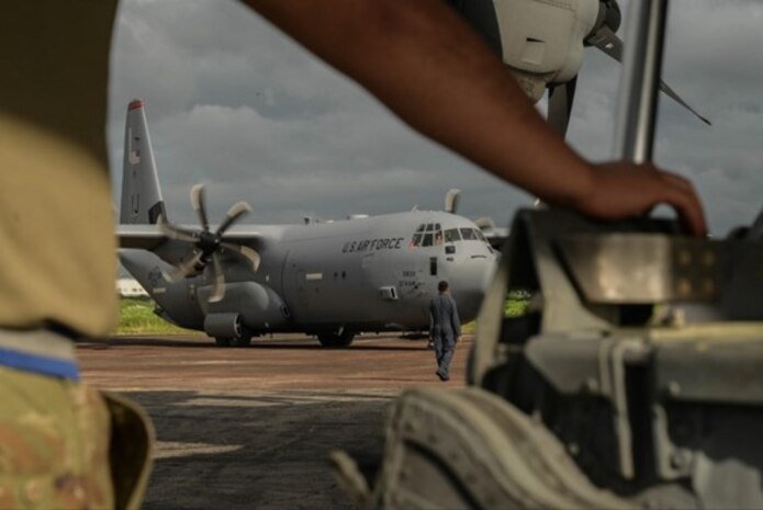 A United States Air Force crew chief watches a C-130J Hercules park during Pacific Angel 25-3 at BAF Base Zahrul Haque in Chittagong, Bangladesh, Sept 12, 2025.