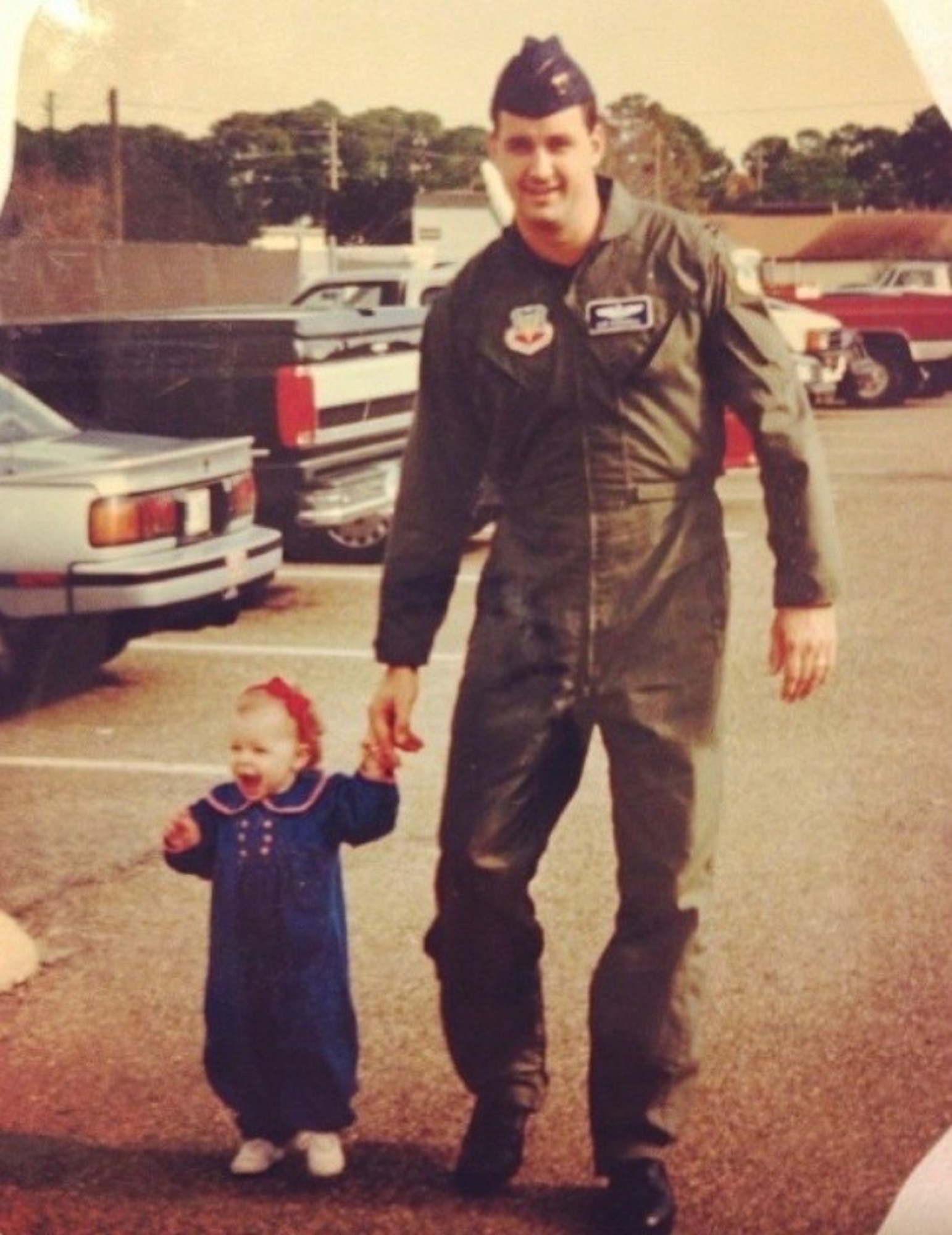 Capt. Cassidy Pickrell, as a child, and her father Capt. Robert Pickrell Jr., now retired, pose for a picture outside the 53rd Weather Reconnaissance Squadron, at Keesler Air Force Base, Mississippi. Cassidy currently pilots the C-17 Globemaster III for the 313th Airlift Squadron at Joint base Lewis McChord.