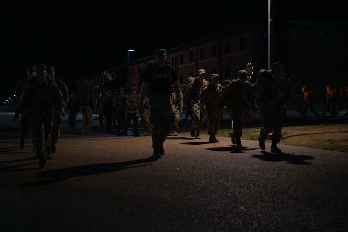 Army soldiers attached to the 344th Military Intelligence Battalion ruck during the 9/11 Memorial Physical Training Event at Goodfellow Air Force Base