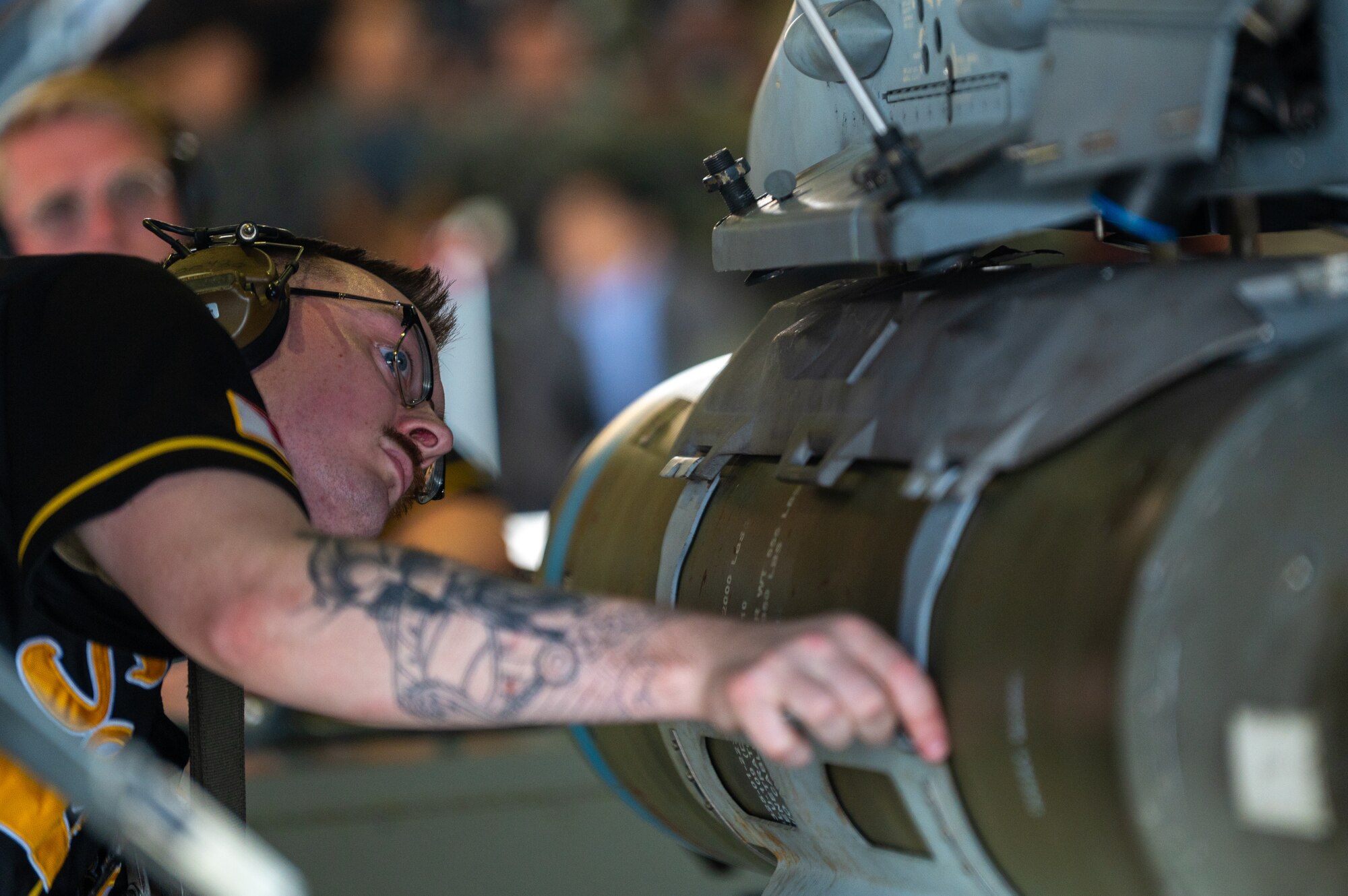 A U.S. Air Force Airman assigned to the 35th Maintenance Group checks the connection of munitions on an F-16 Fighting Falcon during a demonstration at Misawa Air Base, Japan, Sept. 12, 2025.