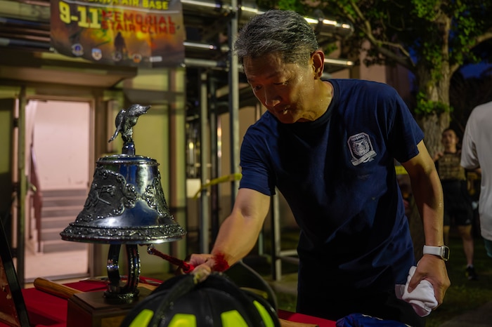 A participant completes the 9/11 remembrance stair climb and rings a bell at Misawa Air base, Japan. Sept 11, 2025.
