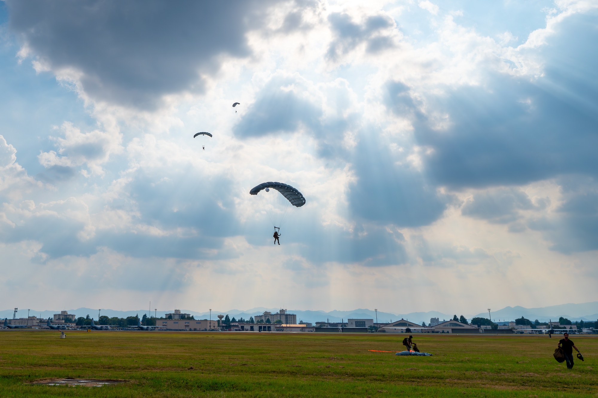 Service members descend onto the drop zone.