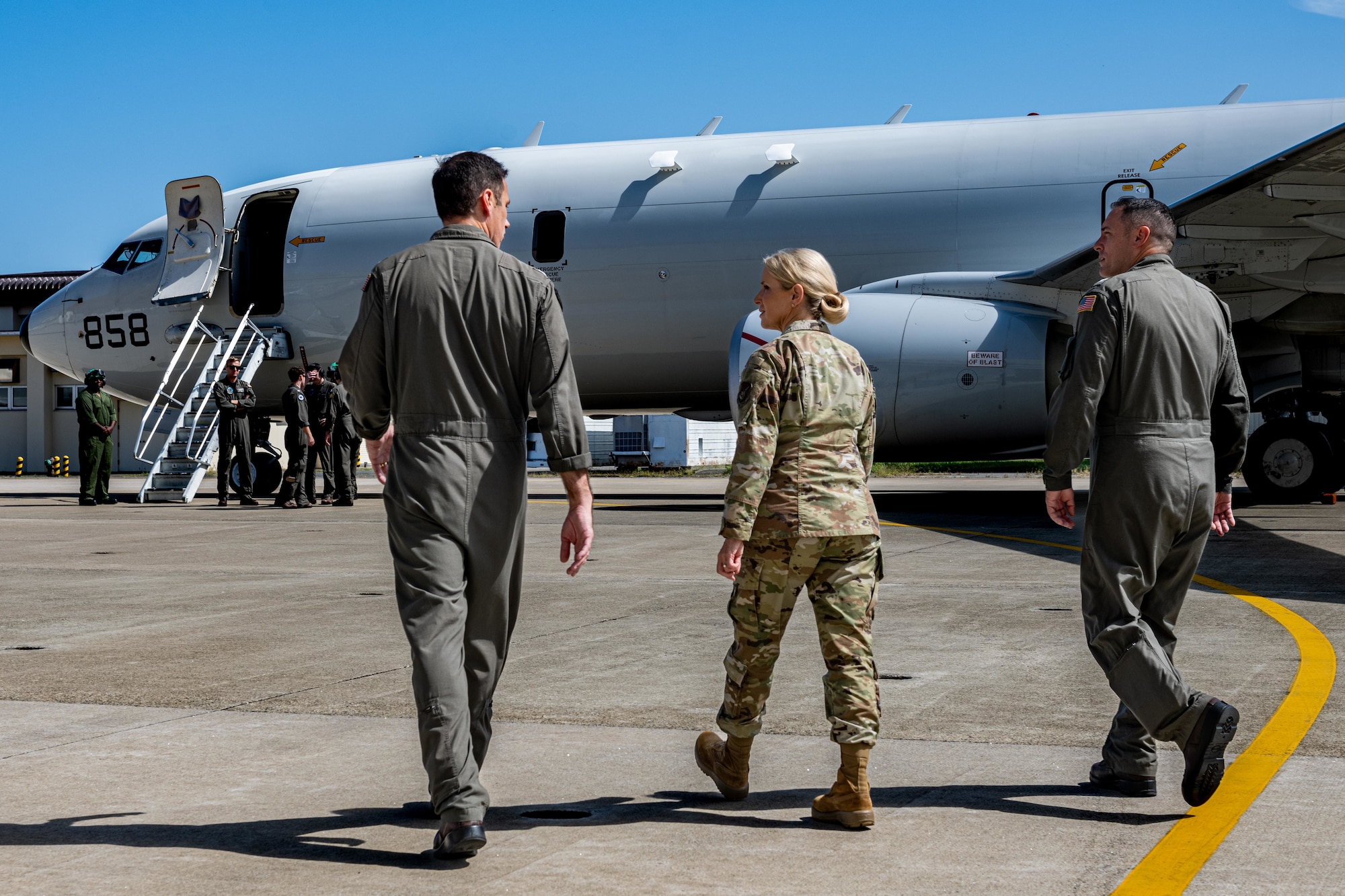 U.S. Air Force Lt. Gen. Laura Lenderman, center, Pacific Air Forces deputy commander, walks towards a U.S. Navy P-8A Poseidon during a tour.